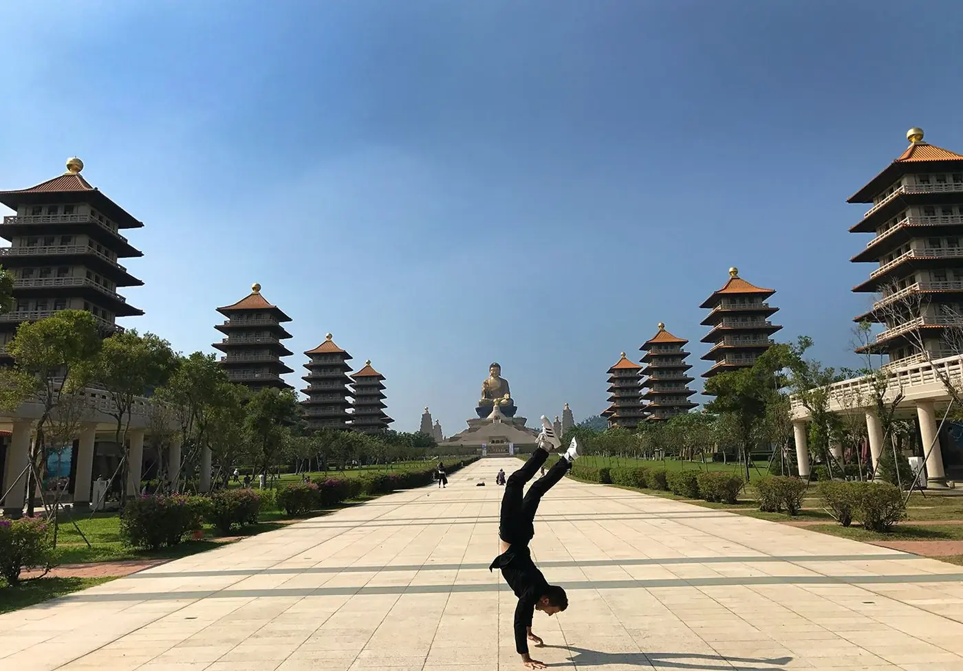 Danny doing a handstand between pagodas