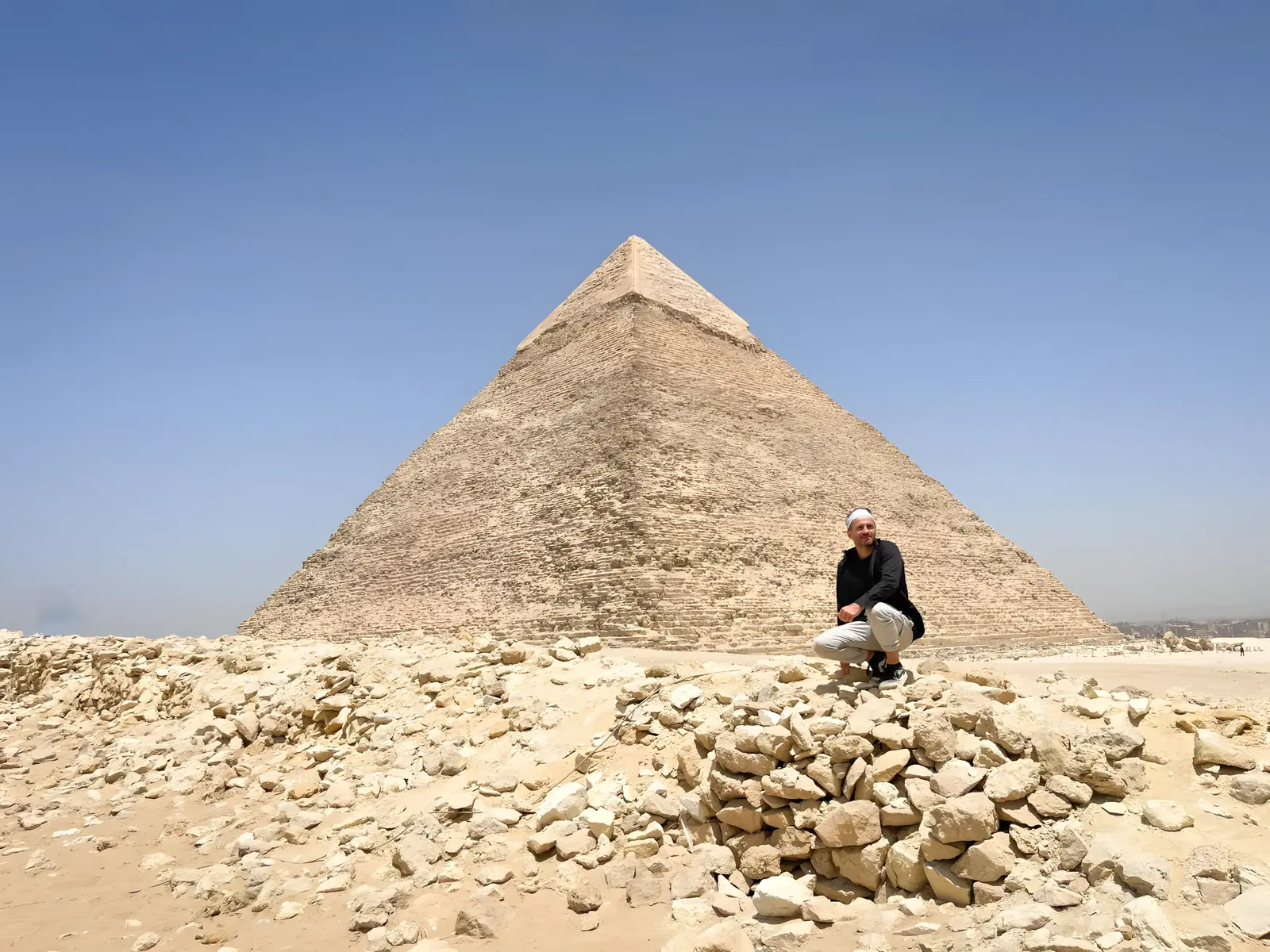 Danny crouching below the Great Pyramid of Giza
