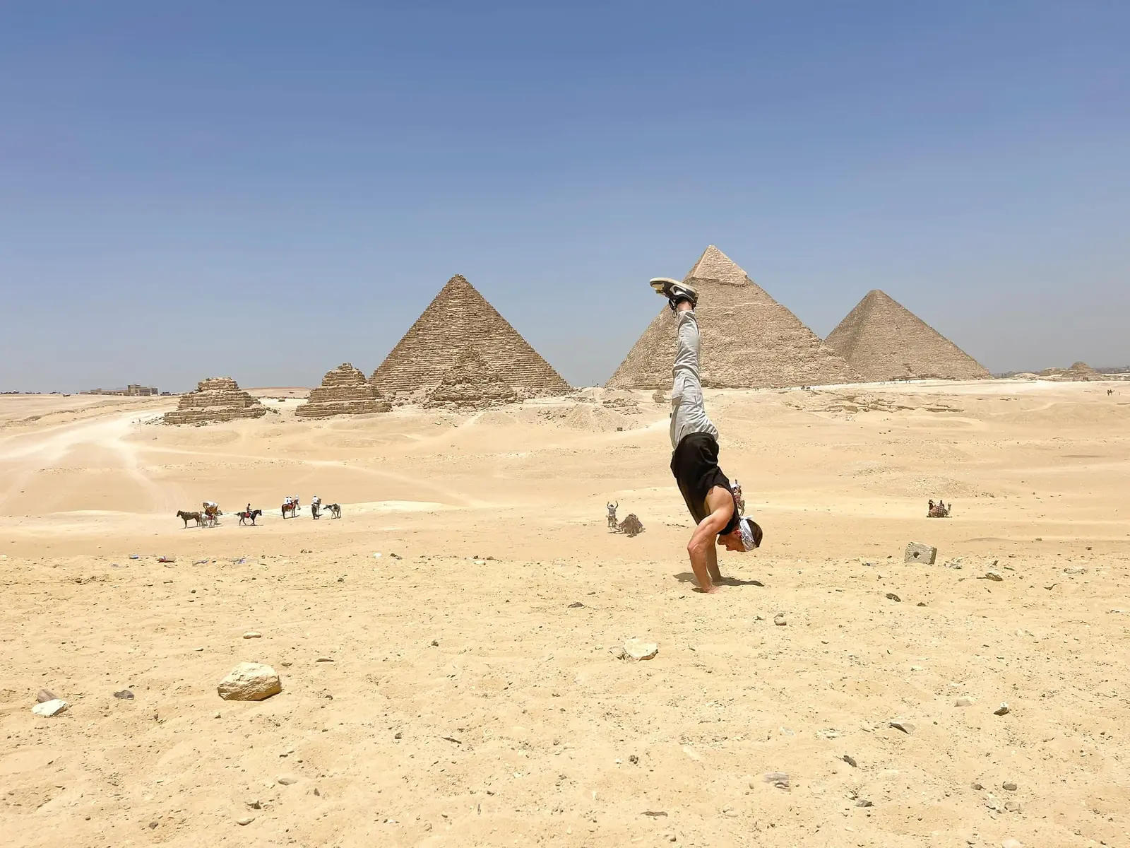 Danny doing a handstand in front of the pyramids