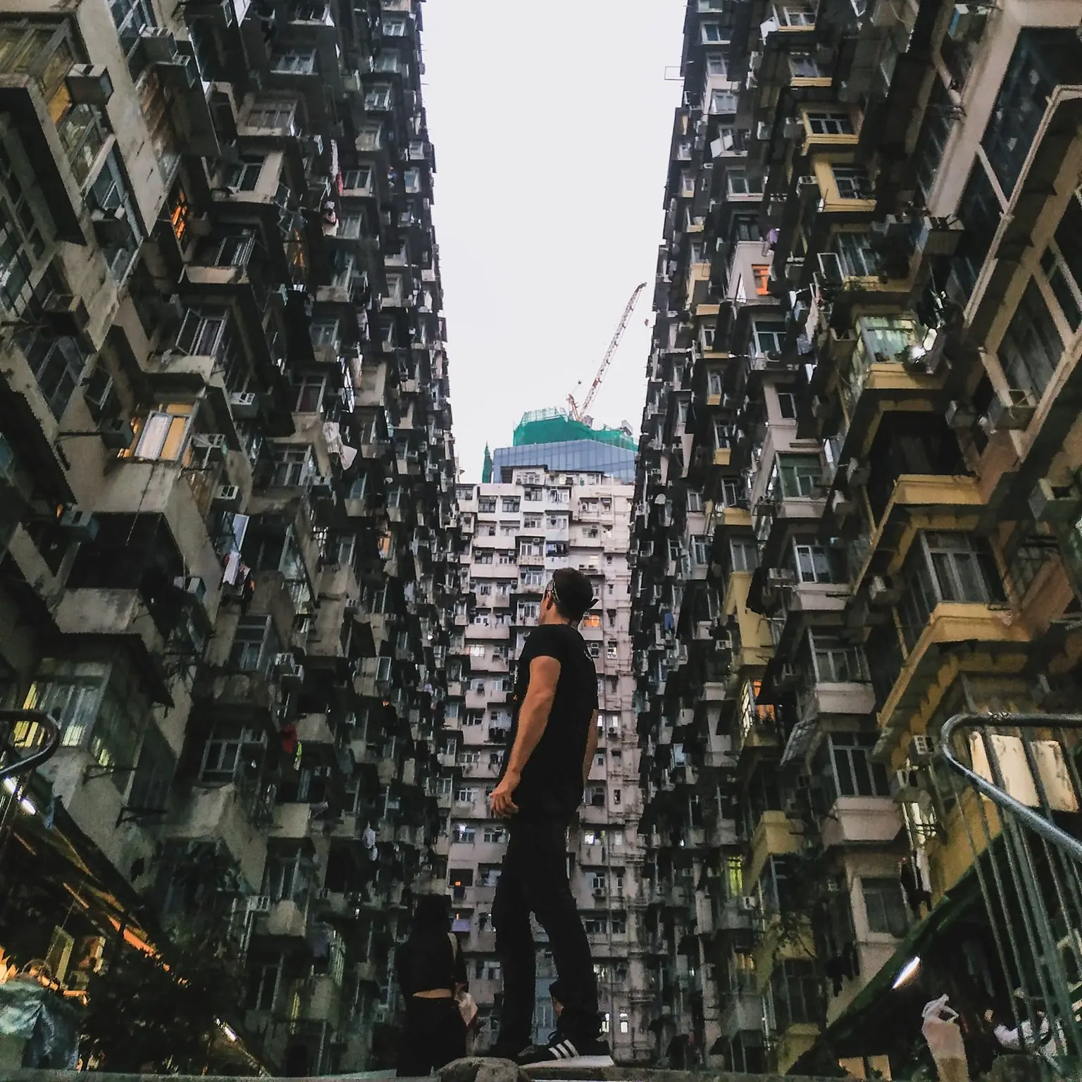 Danny between towering apartment blocks in Hong Kong