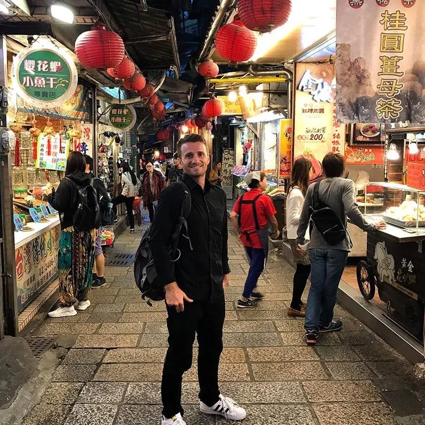 Danny in a lantern-lit market street
