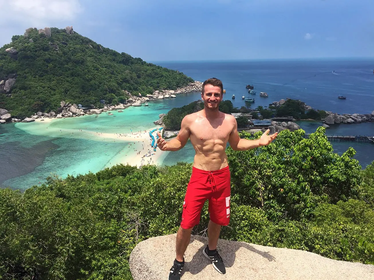 Danny on a lookout above a turquoise bay
